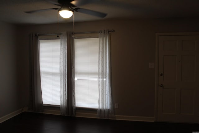 spare room with baseboards and ceiling fan