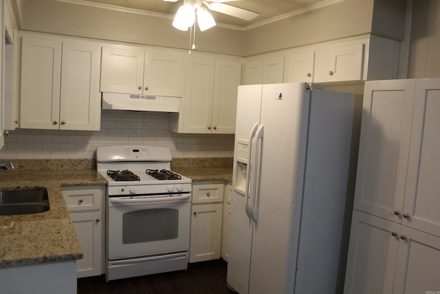 kitchen with white appliances, ornamental molding, decorative backsplash, under cabinet range hood, and white cabinetry