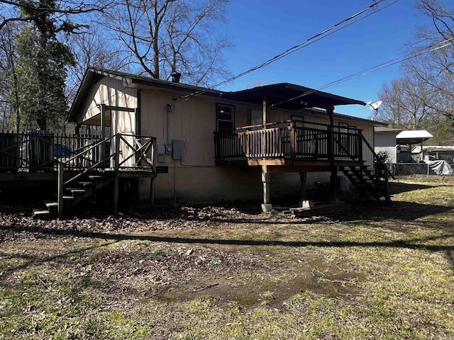 view of home's exterior with a lawn, stairs, and a deck