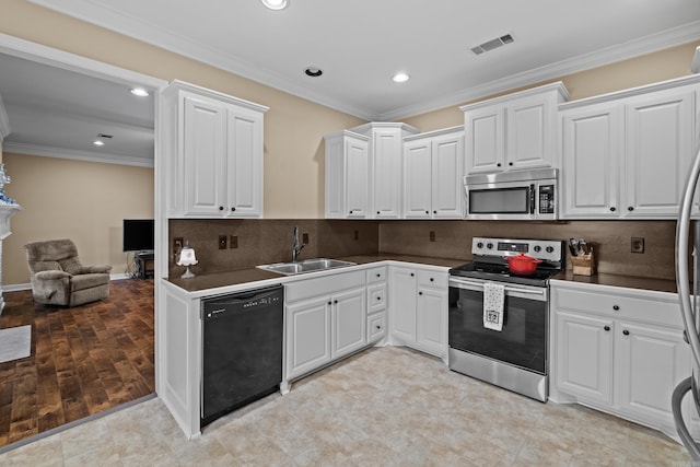 kitchen with dark countertops, visible vents, appliances with stainless steel finishes, and a sink