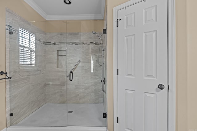 bathroom with a shower stall and crown molding