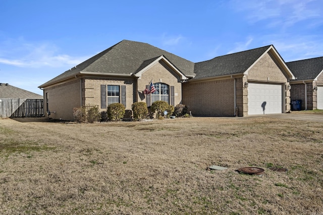 ranch-style home with brick siding, roof with shingles, concrete driveway, and an attached garage