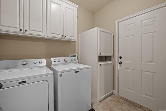 laundry area with cabinet space and separate washer and dryer