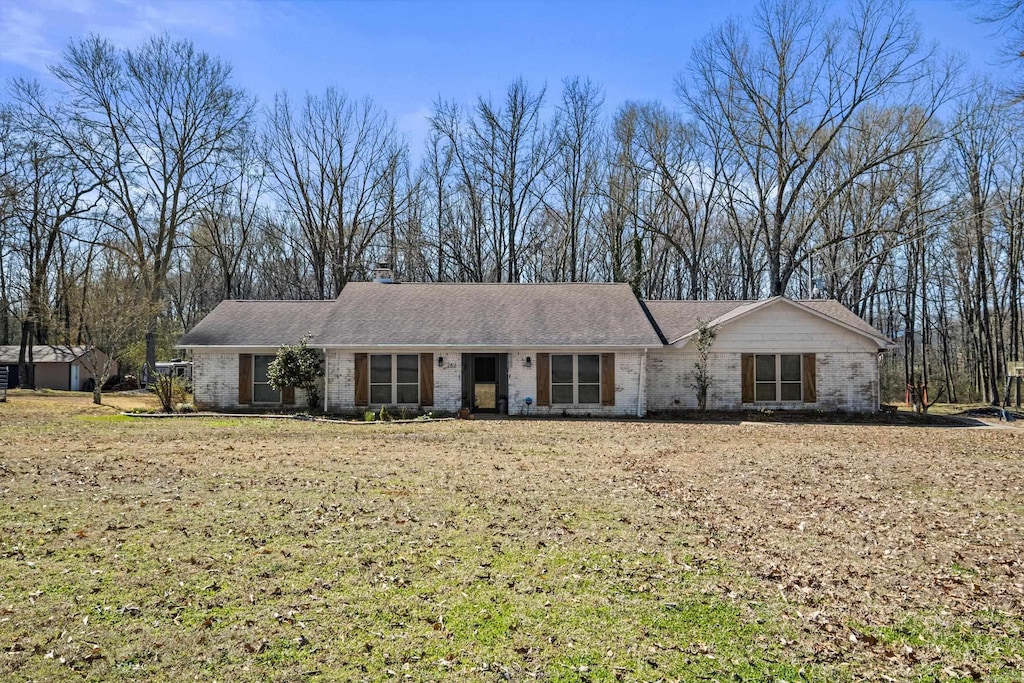ranch-style house featuring brick siding