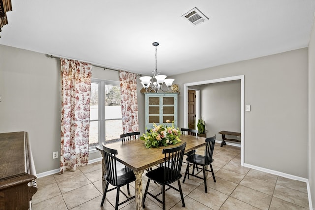 dining room featuring visible vents, baseboards, a notable chandelier, and light tile patterned flooring