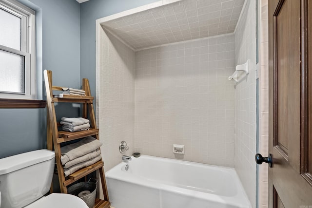 bathroom with shower / bathing tub combination and toilet