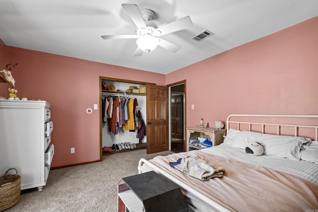 carpeted bedroom with visible vents, baseboards, a closet, and a ceiling fan