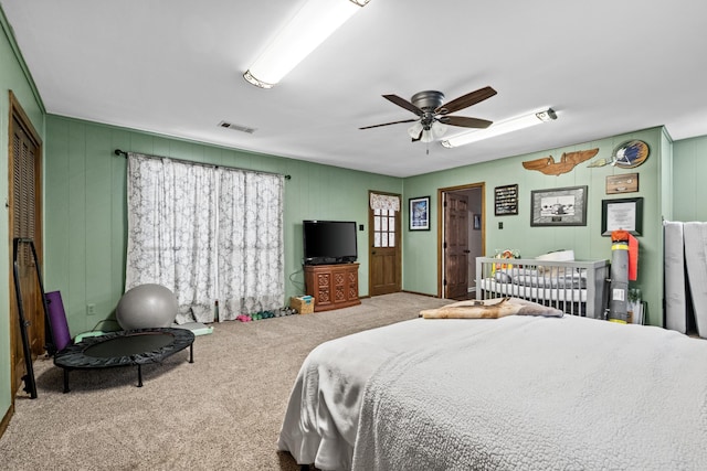 bedroom with visible vents, a ceiling fan, and carpet flooring