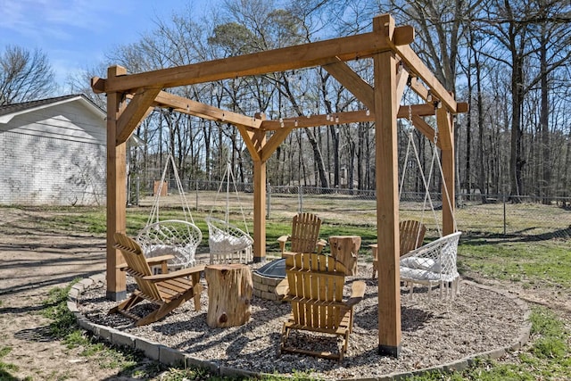 view of yard featuring a fire pit and fence