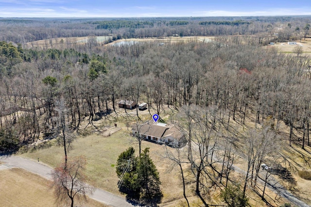 birds eye view of property featuring a rural view and a wooded view