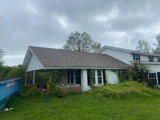 view of property exterior with a shingled roof