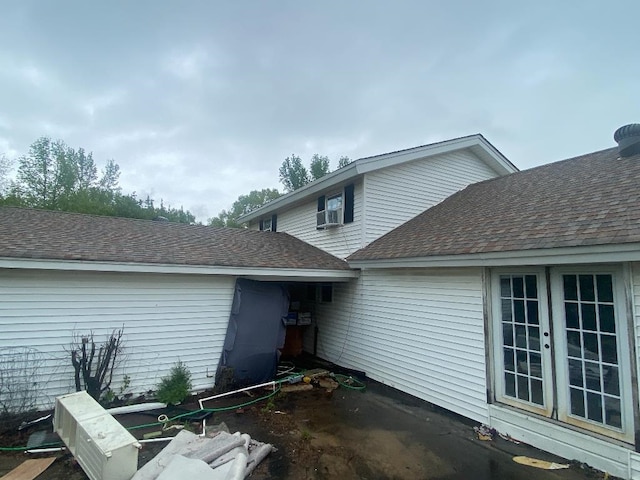 exterior space with roof with shingles