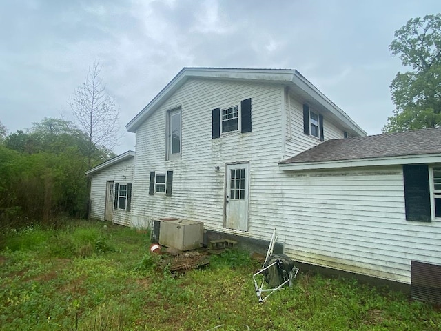 rear view of property with central AC unit