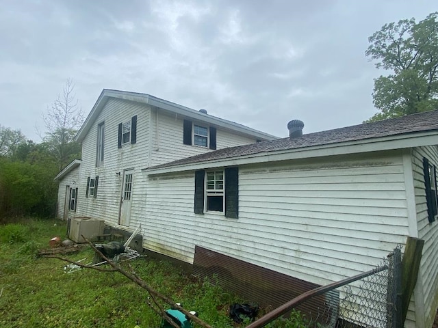 view of side of home with central AC unit