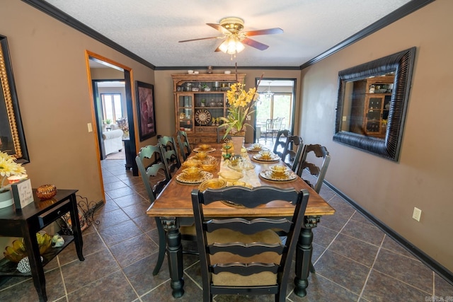 dining area with a textured ceiling, a ceiling fan, baseboards, and ornamental molding