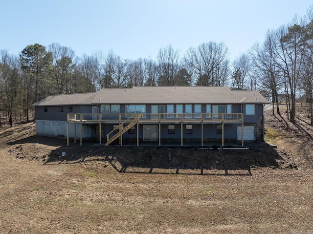 back of property with stairs and a deck