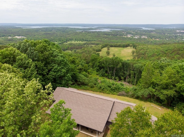 drone / aerial view featuring a wooded view