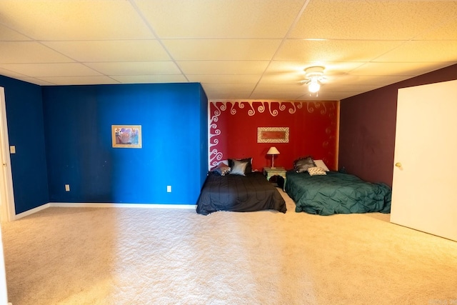 bedroom with baseboards, a paneled ceiling, and carpet flooring