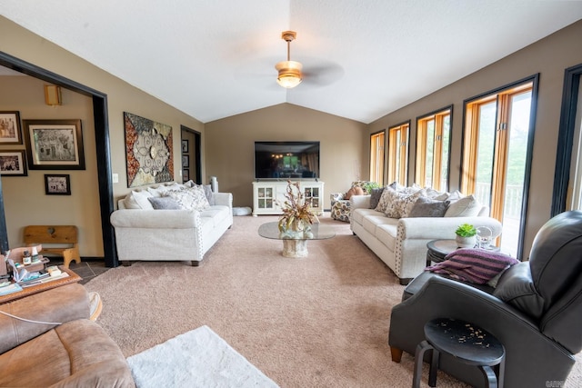 carpeted living room with lofted ceiling and ceiling fan