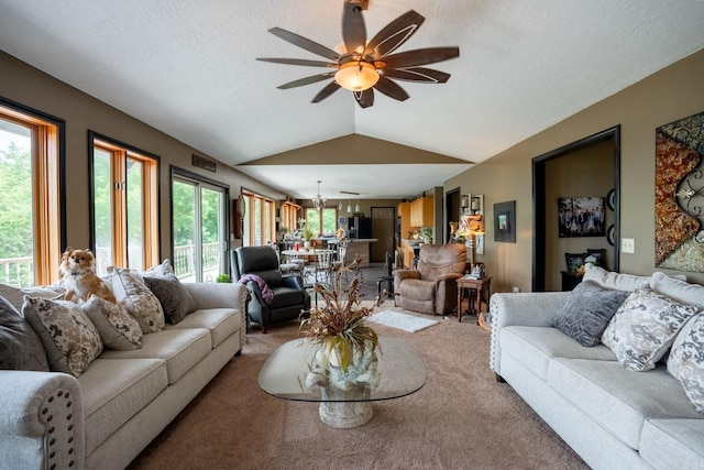 living area with a wealth of natural light, light colored carpet, and lofted ceiling