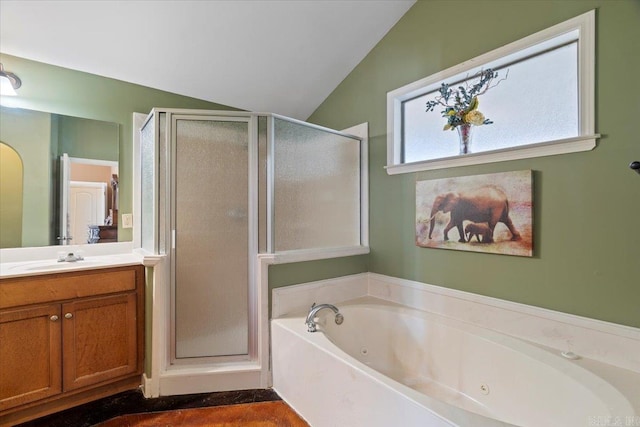 bathroom featuring vanity, a shower stall, a jetted tub, and lofted ceiling