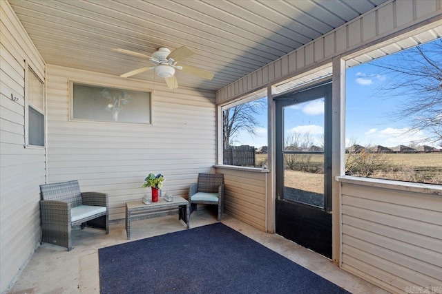 sunroom featuring a ceiling fan