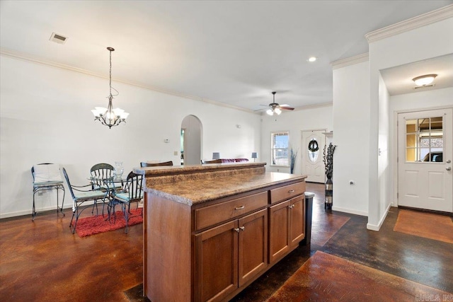 kitchen featuring hanging light fixtures, brown cabinets, finished concrete flooring, and baseboards