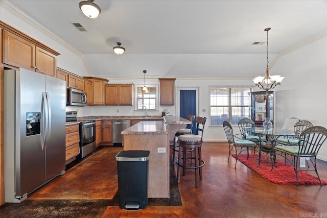 kitchen with visible vents, a sink, a kitchen breakfast bar, finished concrete flooring, and stainless steel appliances