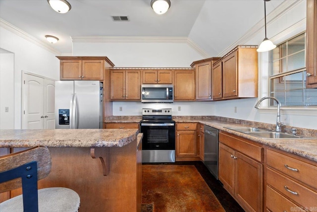 kitchen featuring brown cabinetry, visible vents, appliances with stainless steel finishes, and a sink