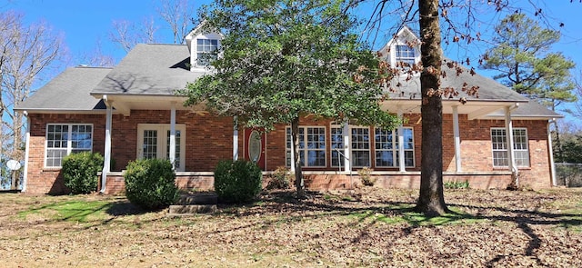 new england style home with brick siding