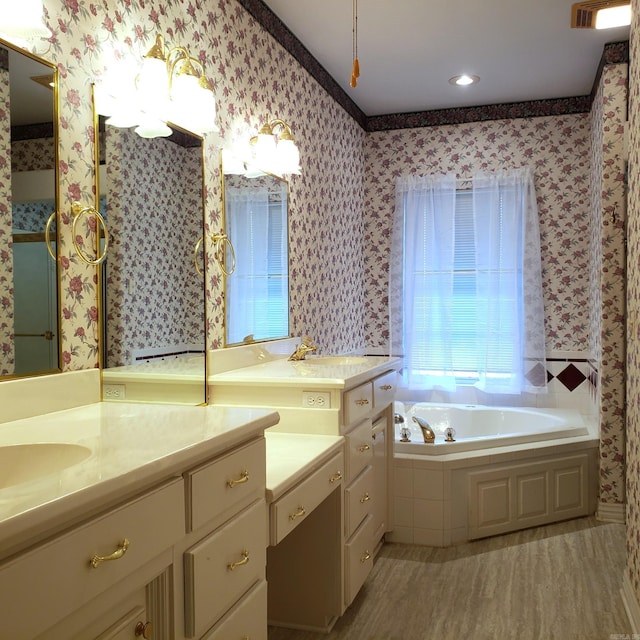 bathroom featuring visible vents, wallpapered walls, a garden tub, wood finished floors, and vanity