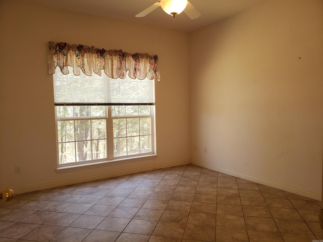 unfurnished room featuring tile patterned floors, baseboards, and a ceiling fan