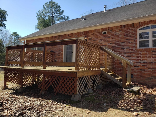 back of property with a wooden deck, brick siding, and a shingled roof