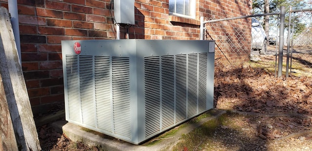 details featuring central air condition unit and brick siding