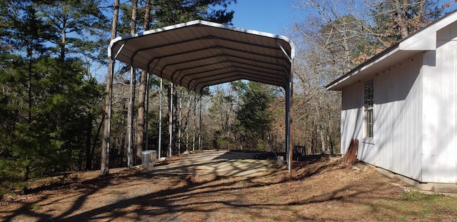 exterior space featuring a detached carport and dirt driveway