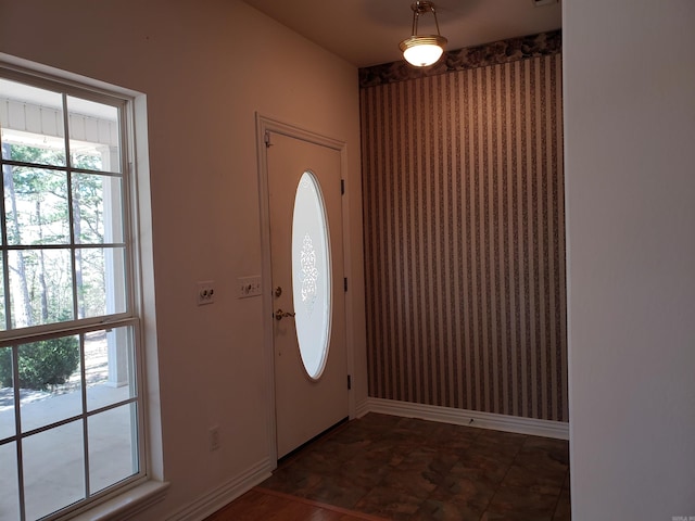 foyer featuring baseboards