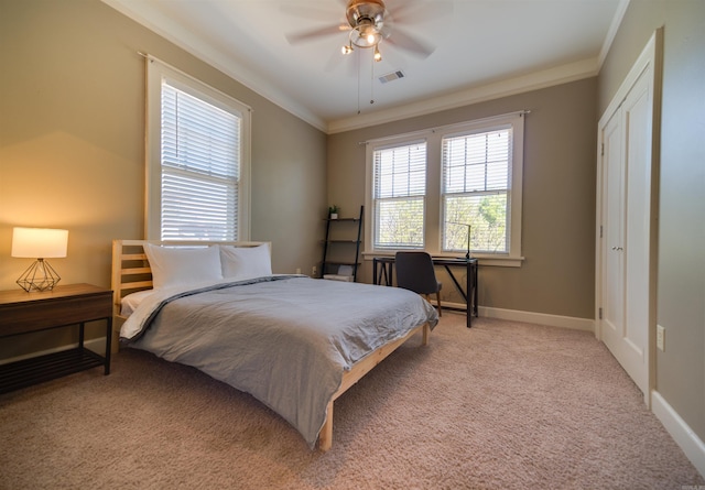 bedroom featuring a ceiling fan, visible vents, baseboards, ornamental molding, and light carpet