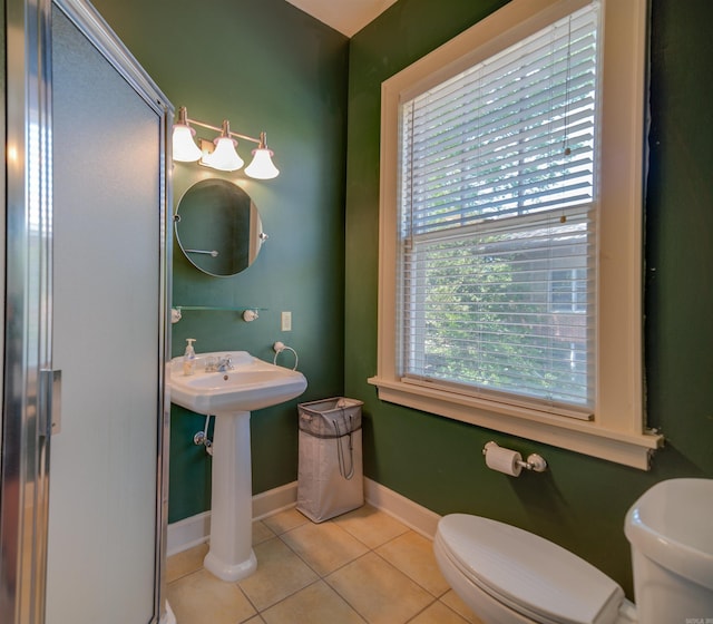 bathroom with tile patterned floors, toilet, and baseboards