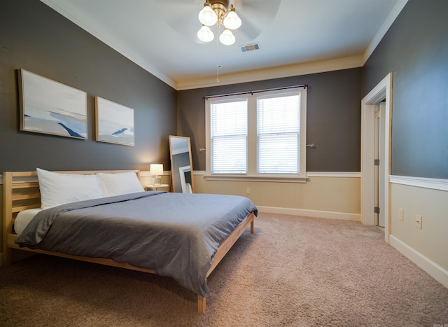 bedroom featuring visible vents, ornamental molding, baseboards, and carpet floors