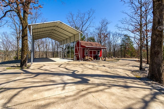 view of shed with a detached carport and concrete driveway