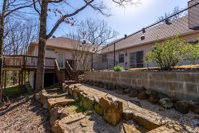 rear view of house featuring a deck and stairway