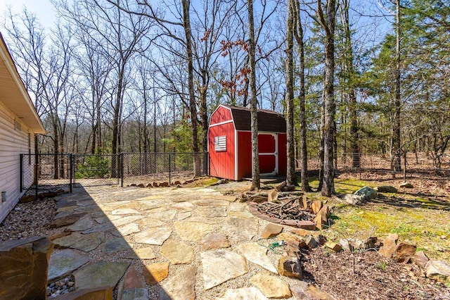 view of patio with a shed, an outdoor structure, and fence