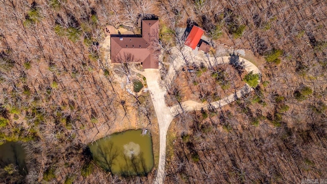 drone / aerial view featuring a forest view and a water view