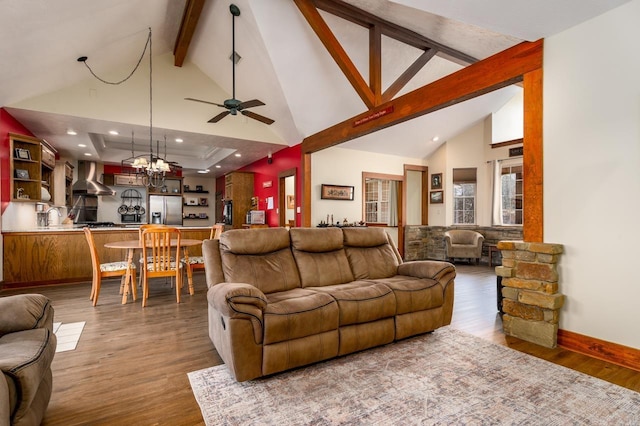 living area featuring beamed ceiling, wood finished floors, and high vaulted ceiling