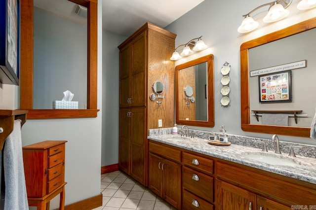 full bath featuring a sink, visible vents, double vanity, and tile patterned floors