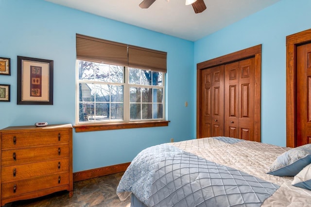 bedroom featuring baseboards, a closet, and ceiling fan