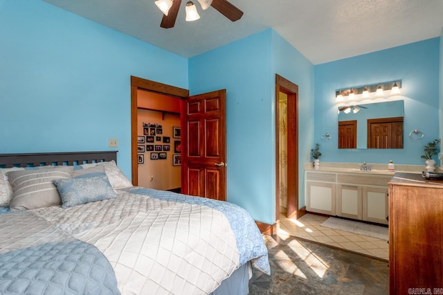 bedroom with a sink, connected bathroom, and ceiling fan