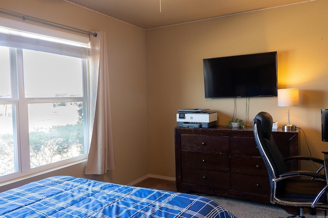 carpeted bedroom featuring baseboards