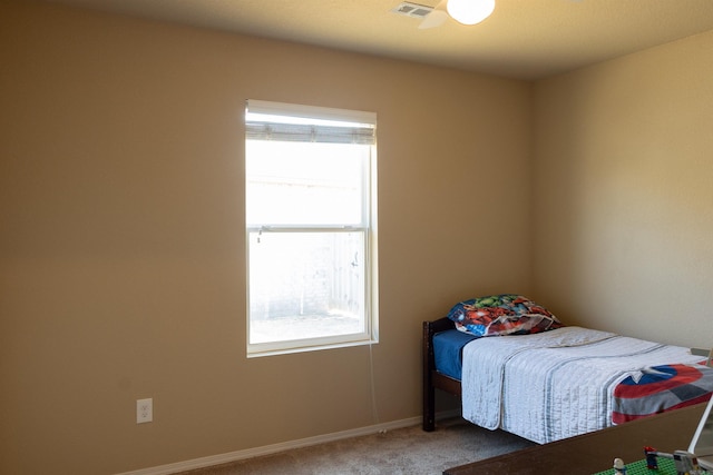 carpeted bedroom with visible vents and baseboards