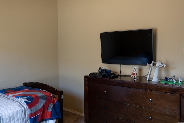 carpeted bedroom featuring baseboards